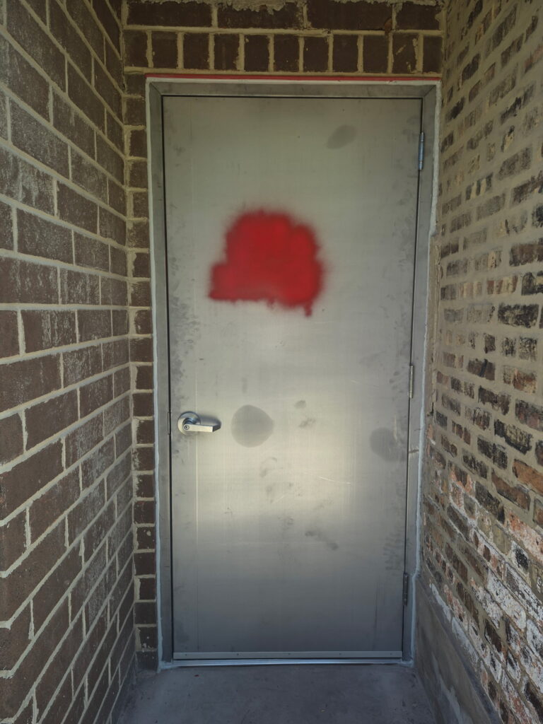 Exterior view of a Chicago commercial steel door and keyed lever handle installed by Omega Locksmith